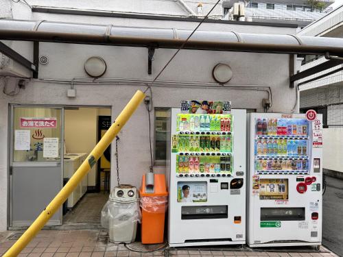two refrigerators are parked in front of a building at #45#46 2-factor authentication Shinjuku in Tokyo
