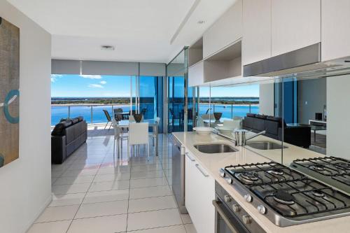 an open kitchen with a view of the ocean at Silvershore Apartments on the Broadwater in Gold Coast