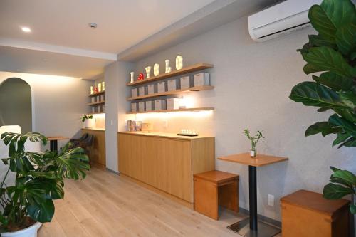 a waiting room with a counter and a table at Yolo Hotel in Tokyo