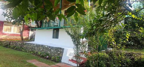 a house with a balcony on the side of it at Bougainvilla Mountain Retreat, near Bhimtal in Bhīm Tāl