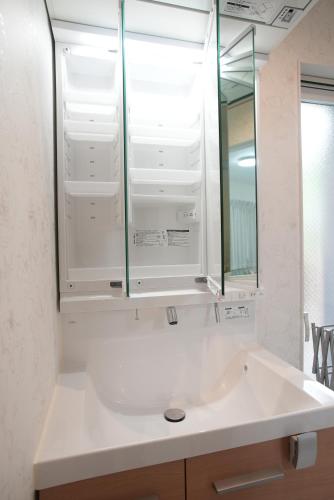 a bathroom with a sink and a mirror at Green Palace Tennoji in Osaka