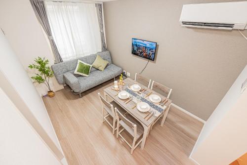 a small living room with a table and a couch at 桜の川70-41 稲荷町駅 近上野-浅草 2-8人丨 Inaricho Station, Near Ueno, Asakusa 2-8 people in Tokyo