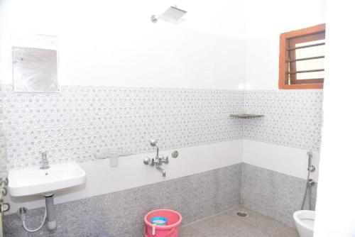 a bathroom with a sink and a toilet at Ganav home stay in Chikmagalūr