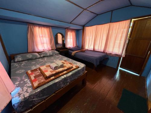 a small bedroom with a bed and a window at Koh Mak Green View Resort in Ko Mak