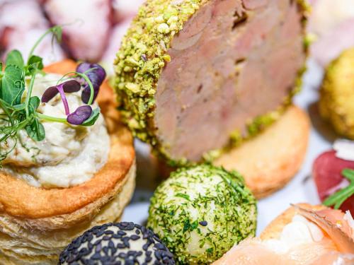 a bunch of different types of food on bread at Mercure Timisoara in Timişoara