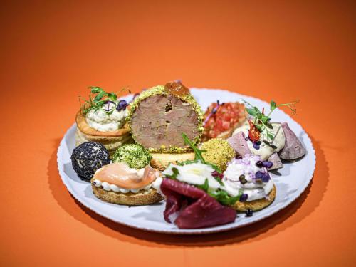 a plate of food with different types of food on it at Mercure Timisoara in Timişoara