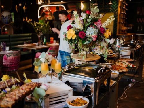 a man standing in front of a buffet of food at Mercure Timisoara in Timişoara