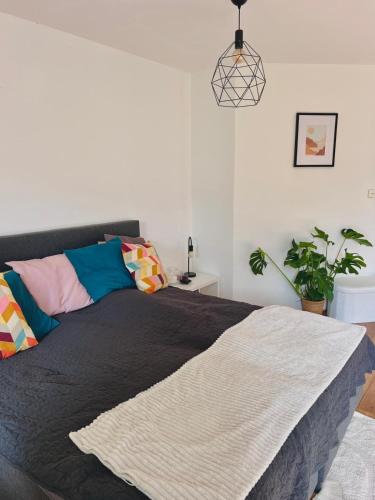 a bedroom with a bed and a potted plant at Big apartment surrounded by nature in Amsterdam in Ons Belang