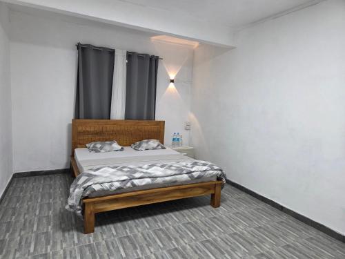 a bedroom with a bed in a room with a window at The Palms Property in Long Mountain