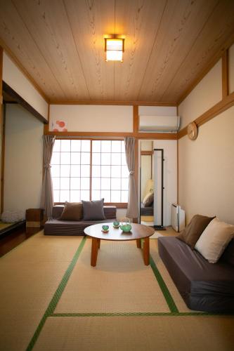 a living room with a couch and a table at Family Stay & Relaxation -Tokyo East- in Tokyo