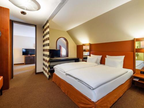 Postel nebo postele na pokoji v ubytování Mövenpick Hotel Egerkingen