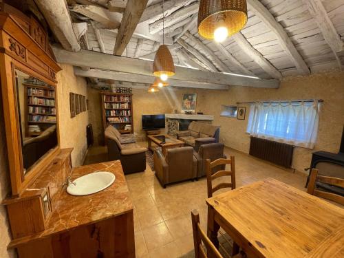 a living room with a couch and a table and chairs at La casa del Abogado in La Urz