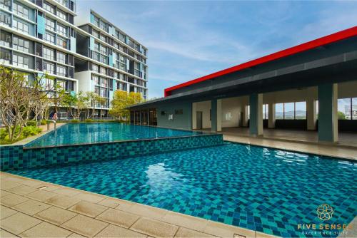 a large swimming pool in front of a building at KIP Core Soho Suite by Five Senses in Sepang