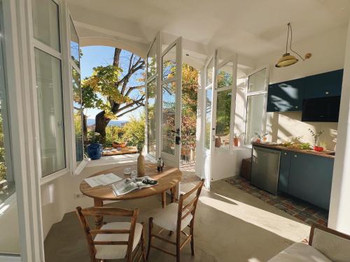 a kitchen and dining room with a table and chairs at Maison La Julianne in Callas