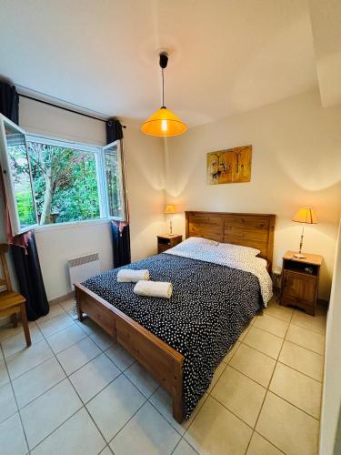 a bedroom with a bed with two towels on it at Le Cersois,proche Canal du Midi et de la Mer, environnement paisible et parking privé in Cers
