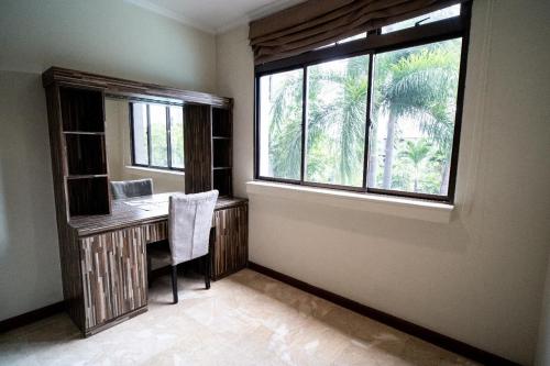 a home office with a desk and a window at Midtown Residence Simatupang Jakarta in Jakarta
