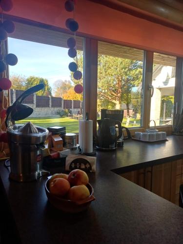 a kitchen with a bowl of fruit on a counter at Holiday house/Brīvdienu māja in Kegums in Ķegums