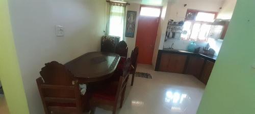 a kitchen with a table and chairs in a room at G shepherd Villas And Apartments in Colva
