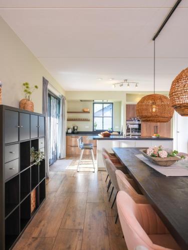 a kitchen with a long dining table and chairs at Polderhuys Goede Hope in Hoofdplaat