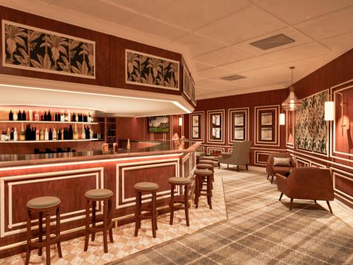 a bar at a hotel with chairs and tables at ANEW Resort Wilderness Garden Route in Wilderness