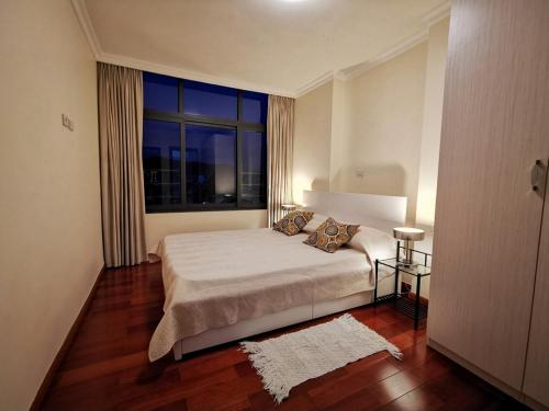 a bedroom with a bed and a large window at Central Location, Breathtaking Views! in Addis Ababa