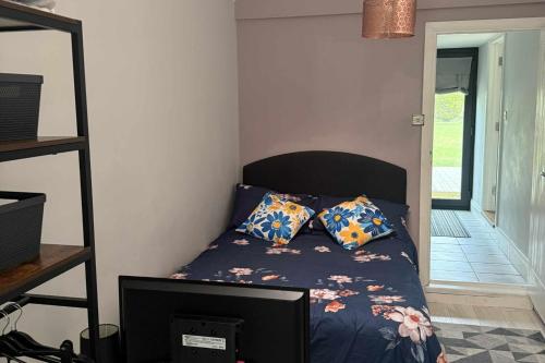 a bedroom with a bed with two pillows on it at 1 Bed Sleeps 2 with Private Garden in Harlow