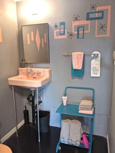 a bathroom with a sink and a mirror and a table at The Studio at Stardust Retreat in Coleman