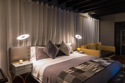 a bedroom with a bed with two lights on it at Dos Casas Hotel & Spa in San Miguel de Allende