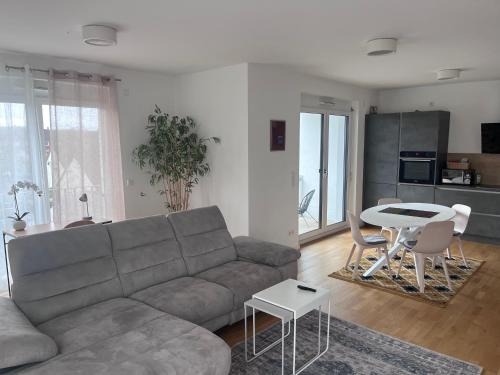 a living room with a couch and a table at Penthouse Supreme HU in Hanau am Main