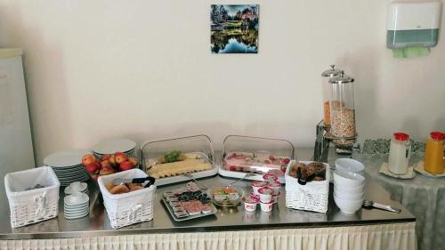 a counter top with a bunch of food on it at Hotel Schillerquartier in Kassel
