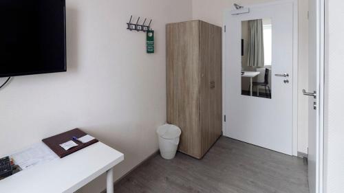 a room with a bathroom with a closet and a toilet at Hotel Schillerquartier in Kassel