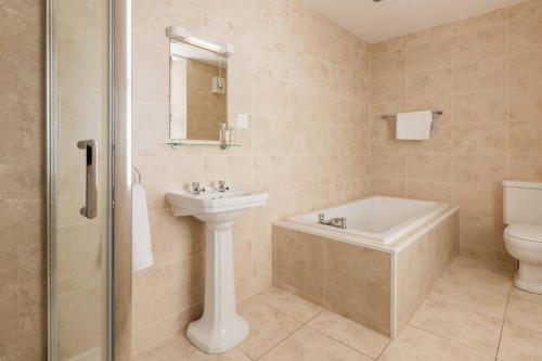 a bathroom with a sink and a tub and a toilet at The Bank in Anstruther