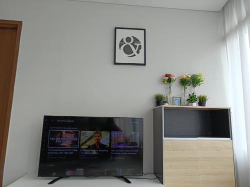 a flat screen tv sitting in a living room at The moon light vortex suits kl in Kuala Lumpur