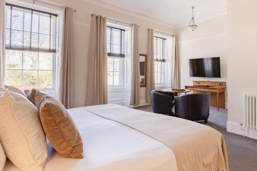 a bedroom with a bed and a desk and a television at The Bank in Anstruther
