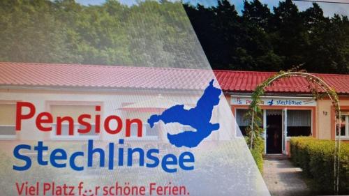 a building with a sign in front of it at Pension Stechlinsee in Neuglobsow