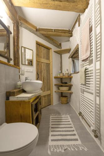 a bathroom with a white toilet and a sink at Domček pod Botanickou záhradou in Banská Štiavnica