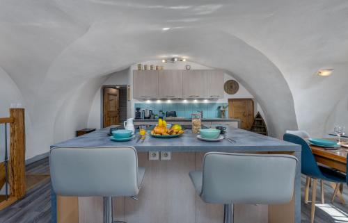 a kitchen with a table with a bowl of fruit on it at Maison à Tour Briançon in Briançon
