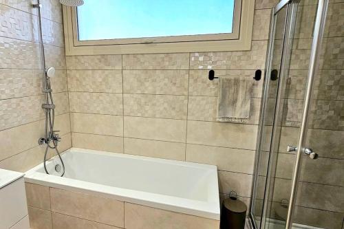a white bath tub in a bathroom with a shower at Pareklisia Mystical Haven in Parekklisha