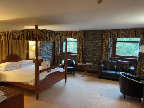 a bedroom with a bed and a living room at Whitewater Hotel & Spa in Newby Bridge