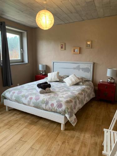 a bedroom with a bed with a stuffed animal on it at Mas Héritage, 1455 route de Balbiac in Rosières
