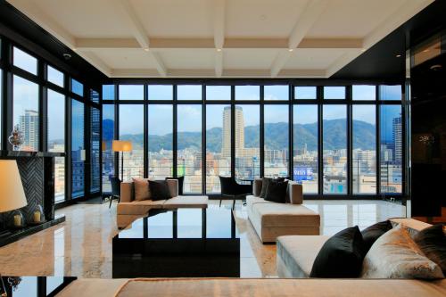 a living room with a view of a city at Candeo Hotels Kobe Tor Road in Kobe