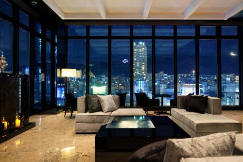 a living room with a view of a city at night at Candeo Hotels Kobe Tor Road in Kobe
