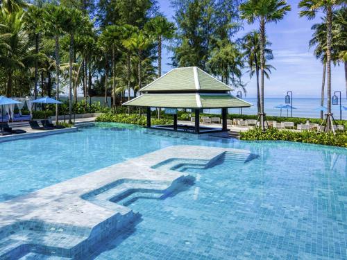 a swimming pool with a gazebo in a resort at Grand Mercure Khao Lak Bangsak in Khao Lak