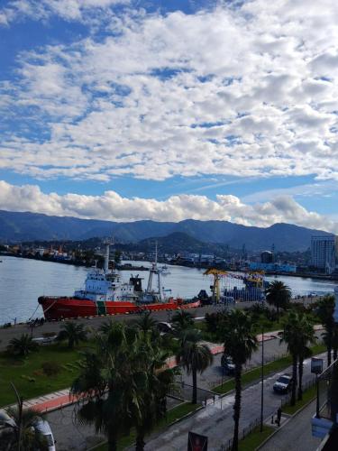 a large red boat in a body of water at Hotel Neon in Batumi
