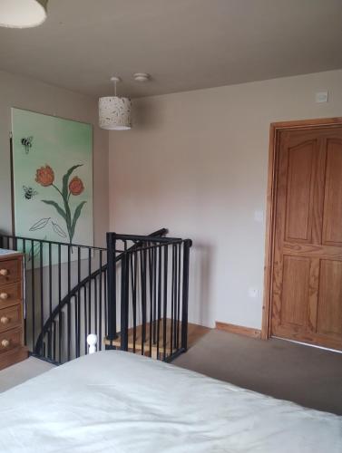 a bedroom with a bed and a wooden door at Peaceful 1 Bed Self-Contained Property with Parking in Wivenhoe