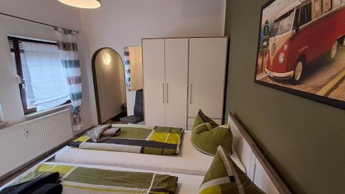 a bedroom with two beds and a painting of a bus at Ferienwohnungen Thon an der Schloßruine in Herbsleben
