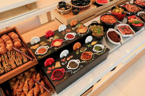 a buffet with many different types of food on display at Candeo Hotels Kobe Tor Road in Kobe