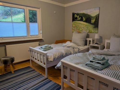 En eller flere senge i et værelse på Cozy Winterwunderland Langlauf, Biking 4 Personen