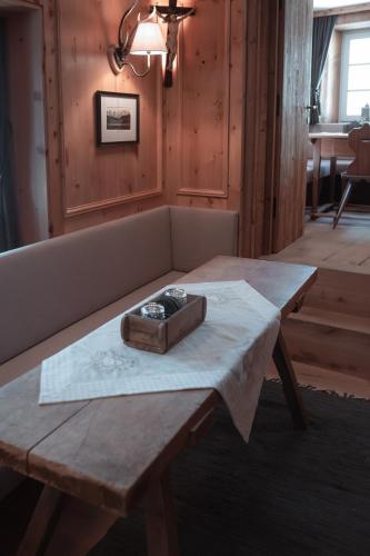 a wooden table with a box on top of it at Löw Chalet Suite 2, Steps from the Slopes by 360 Estates in Kitzbühel