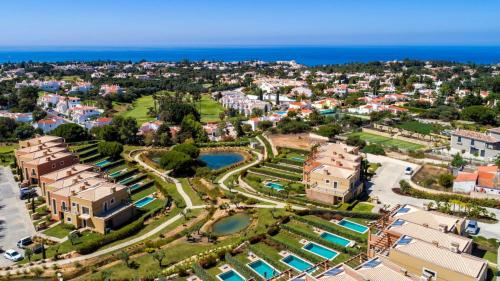 an aerial view of a resort and the ocean at Vale de Milho Village in Carvoeiro